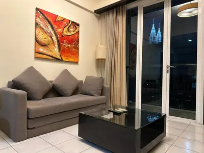 a living room with a couch and a painting on the wall at Seri Bukit Ceylon Bukit Bintang Kuala Lumpur City Centre in Kuala Lumpur