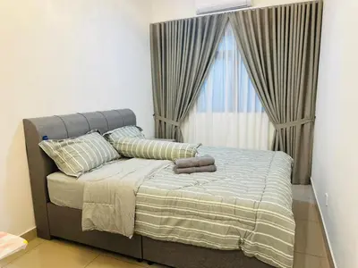 a bedroom with a large bed with a window at Sentul Home Condo-KLCC View with 3bed,3bath, cooking allowed in Kuala Lumpur