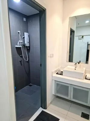 a bathroom with a shower and a sink at Mercu Summer Suites KLCC By ATIQ in Kuala Lumpur