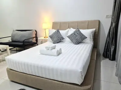a bedroom with a bed with two towels on it at Mercu Summer Suites KLCC By ATIQ in Kuala Lumpur