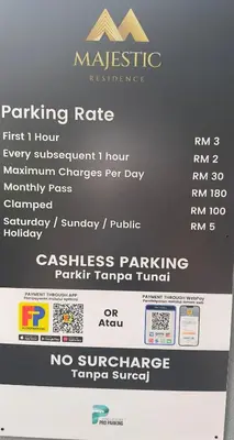 a sign that says parking rate on a parking meter at Private family suite 29171BR at KLCC in Kuala Lumpur