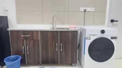 a kitchen with a sink and a washing machine at Private family suite 29171BR at KLCC in Kuala Lumpur