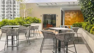 a group of tables and chairs on a patio at Luxury copule suite 232A at KLCC in Kuala Lumpur