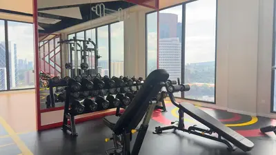 a gym with a view of a city at Luxury copule suite 232A at KLCC in Kuala Lumpur