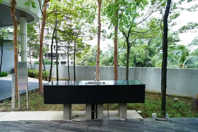 a glass table with a sink in a park at Bukit Bintang Robertson Residences, KLCC in Kuala Lumpur