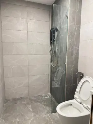 a bathroom with a shower and a toilet at Luxury private family suite 26161BR at KLCC in Kuala Lumpur