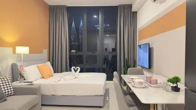a hotel room with a bed and a dining table at Luxury couple suite 295A at KLCC in Kuala Lumpur