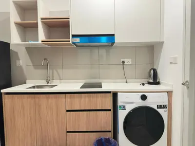 a kitchen with a washing machine and a sink at Luxury couple suite 295A at KLCC in Kuala Lumpur