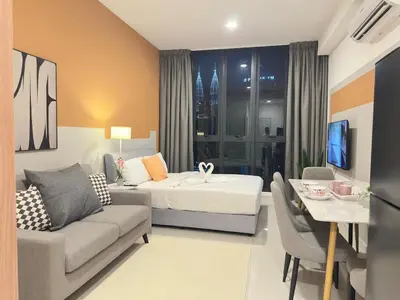 a hotel room with a bed and a living room at Luxury couple suite 295A at KLCC in Kuala Lumpur