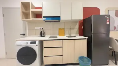 a small kitchen with a refrigerator and a dishwasher at KLCC view couple suite 293B at KLCC in Kuala Lumpur