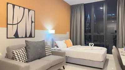 a hotel room with a bed and a couch at Cozy suite for couple 297A at KLCC in Kuala Lumpur