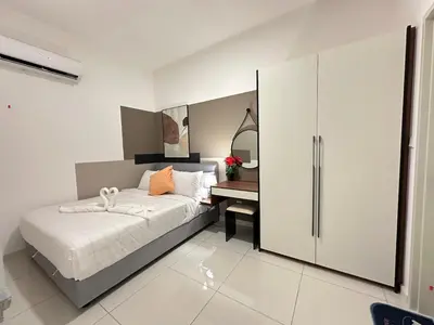 a bedroom with a bed and a desk in it at Private family suite 27171BR at KLCC in Kuala Lumpur
