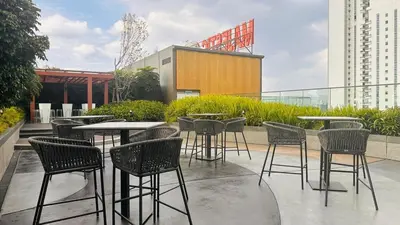 a group of tables and chairs on a patio at Cozy KLCC view suite 305B at KLCC in Kuala Lumpur