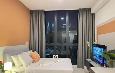 a bedroom with a large window with a view of the city at KLCC view cozy suite 251A at KLCC in Kuala Lumpur