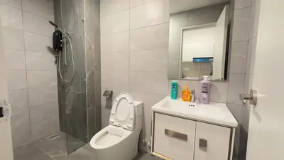 a bathroom with a toilet and a sink and a shower at KLCC view cozy suite 251A at KLCC in Kuala Lumpur