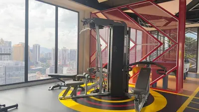 a gym with a treadmill in a room with windows at KLCC view suite 292B at Majestic residence in Kuala Lumpur