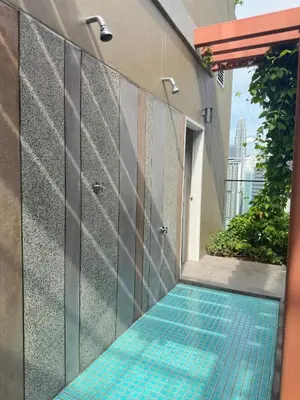 a swimming pool with blue tiles on the side of a building at KLCC view suite 292B at Majestic residence in Kuala Lumpur