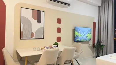 a dining room with a white table and chairs at Luxe suite for couple 297B at Majestic Residence in Kuala Lumpur
