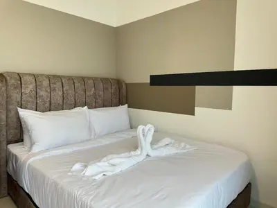 a white towel on a bed in a room at Private family suite 23171BR at Majestic Residence in Kuala Lumpur