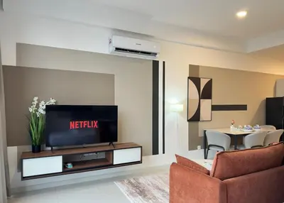a living room with a tv and a couch and a table at Private family suite 23171BR at Majestic Residence in Kuala Lumpur