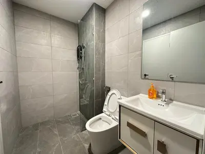 a bathroom with a toilet and a sink and a shower at Private family suite 23171BR at Majestic Residence in Kuala Lumpur