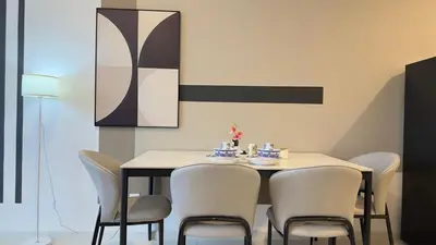 a dining room with a table and chairs at Private family suite 23171BR at Majestic Residence in Kuala Lumpur