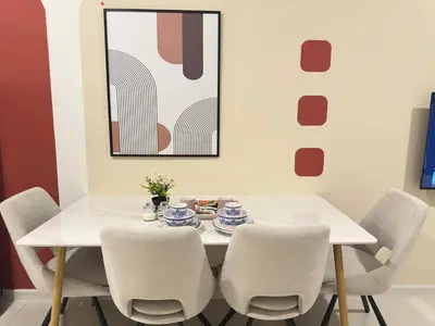 a dining room with a white table and chairs at Klcc view Luxe suite 295B at Majestic Residence in Kuala Lumpur