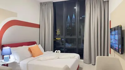 a bedroom with a bed and a large window with a view at KLCC view luxury suite 276B at Majestic residence in Kuala Lumpur