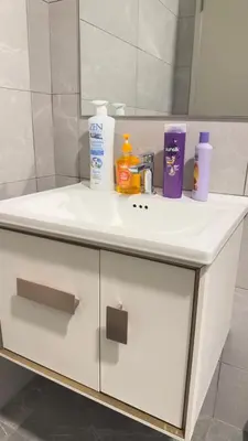 a white bathroom sink with toiletries on it at Private family suite 29201BR at Majestic Residence in Kuala Lumpur