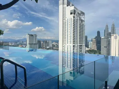 a swimming pool with a view of a city at Private family service suite 2613A1BR at Majestic Residence in Kuala Lumpur