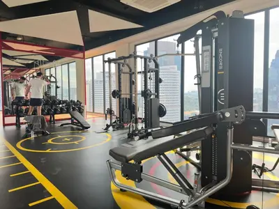 a gym with tread machines and people in the background at Cozy suite for couple 275A at Majestic Residence in Kuala Lumpur