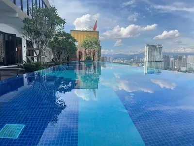 a large swimming pool with a view of a city at Cozy suite for couple 275A at Majestic Residence in Kuala Lumpur