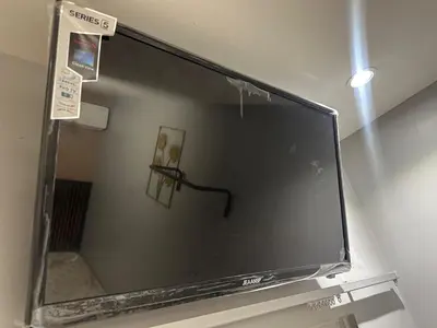 a large flat screen tv hanging on a wall at SS GREY INN Bb in Kuala Lumpur
