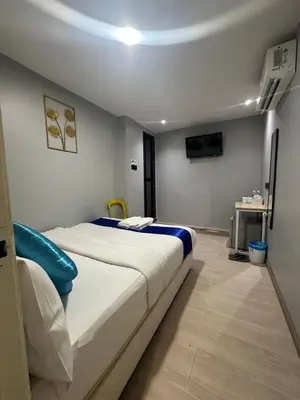 a bedroom with a large white bed in a room at SS GREY INN Bb in Kuala Lumpur