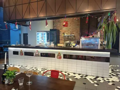 a restaurant with a counter and a table and chairs at Binjai 8 Comfort Hospitality in Kuala Lumpur