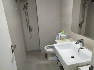a bathroom with a toilet and a sink and a mirror at Binjai 8 Comfort Hospitality in Kuala Lumpur