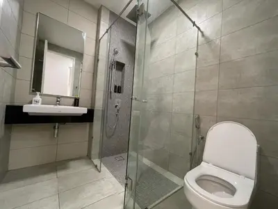 a bathroom with a toilet and a sink and a shower at Sentral Suites KL Sentral Kuala Lumpur by Nestaway in Kuala Lumpur