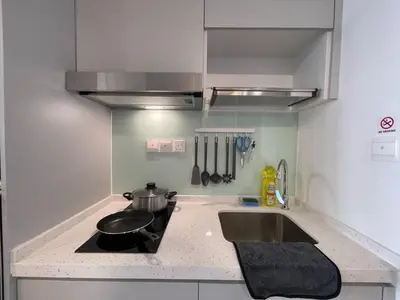 a kitchen with a sink and a stove with a pot on it at The Riv Riveria City KL Sentral Kuala Lumpur by Nestaway in Kuala Lumpur
