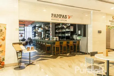 a restaurant with a bar and some chairs and tables at The Pureloft Suites - Bukit Bintang KLCC in Kuala Lumpur