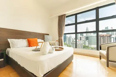 a bedroom with a bed and a large window at The Pureloft Suites - Bukit Bintang KLCC in Kuala Lumpur