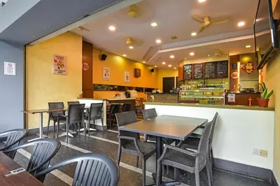 a dining room with tables and chairs in a restaurant at The Pureloft Suites - Bukit Bintang KLCC in Kuala Lumpur