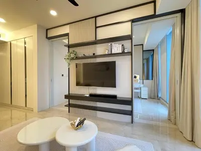 a living room with a television and a white table at Romantic Home in KLCC in Kuala Lumpur