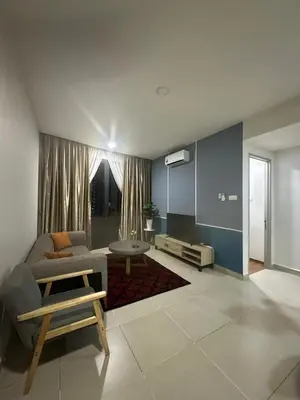 a living room with a couch and a table at KL Gateway Premium Service Residence At University malaya in Kuala Lumpur