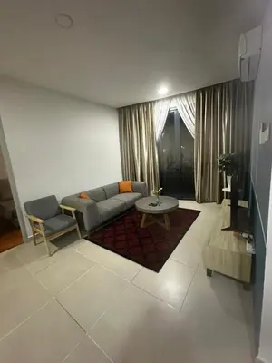 a living room with a couch and a table at KL Gateway Premium Service Residence At University malaya in Kuala Lumpur
