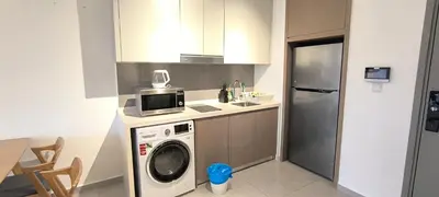 a kitchen with a washing machine and a microwave at Service Apartment Agile Residence KL in Kuala Lumpur