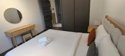 a living room with a white couch and a mirror at Service Apartment Agile Residence KL in Kuala Lumpur