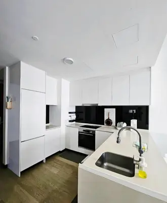 a kitchen with white cabinets and a sink at Star residence KLCC by J&K in Kuala Lumpur