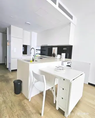 a white kitchen with a table and a sink at Star residence KLCC by J&K in Kuala Lumpur