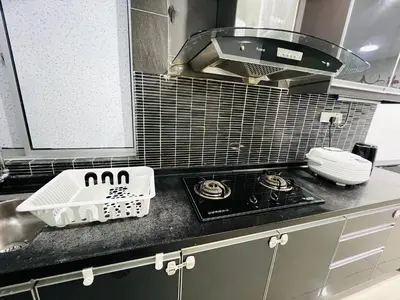 a kitchen counter with a sink and a drying rack at Homestay Ustaz Lumayan in Kuala Lumpur