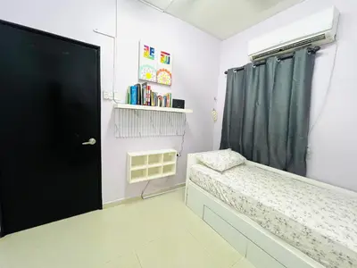 a bedroom with a bed and a black door at Homestay Ustaz Lumayan in Kuala Lumpur